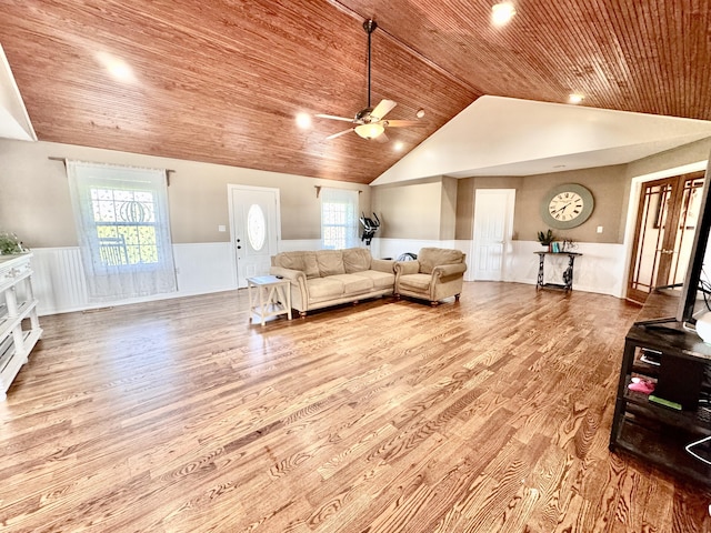 living room featuring wood ceiling, ceiling fan, vaulted ceiling, wood finished floors, and a wainscoted wall