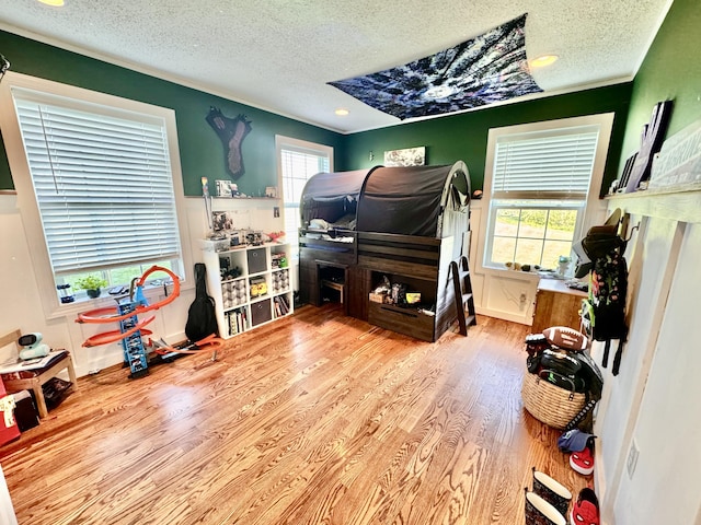 bedroom featuring a textured ceiling and wood finished floors