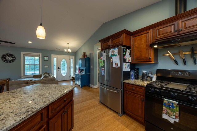 kitchen featuring pendant lighting, black range with gas stovetop, light wood-style floors, under cabinet range hood, and high end fridge