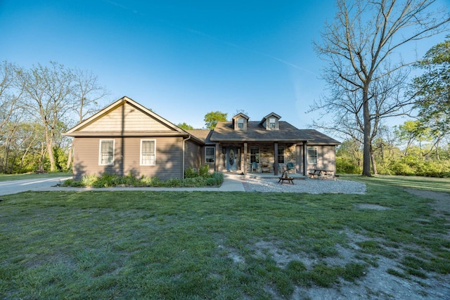 rear view of property with a lawn and a porch