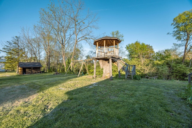 view of yard featuring a gazebo, an outbuilding, and stairway