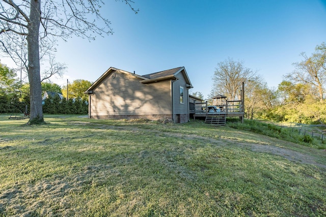view of property exterior with a yard and a deck