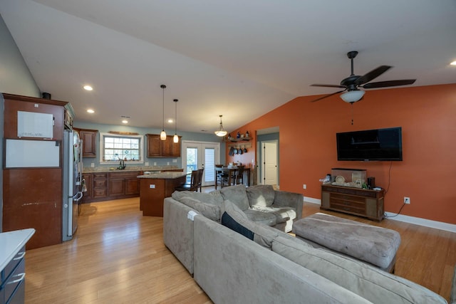 living room featuring recessed lighting, ceiling fan, light wood-type flooring, and lofted ceiling