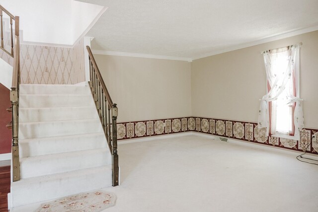 staircase featuring crown molding, carpet floors, and visible vents