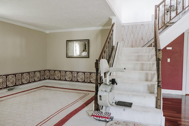 staircase featuring baseboards, ornamental molding, and wood finished floors