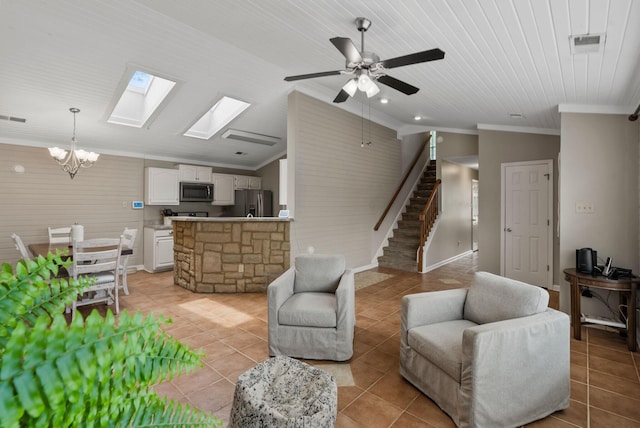 living area with light tile patterned flooring, stairway, ornamental molding, and lofted ceiling with skylight