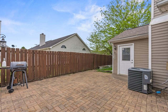 view of patio / terrace with fence and central AC unit