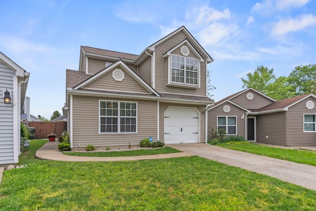 traditional-style house featuring a garage, a front lawn, fence, and concrete driveway