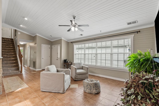 living area with visible vents, vaulted ceiling, light tile patterned floors, ornamental molding, and stairs
