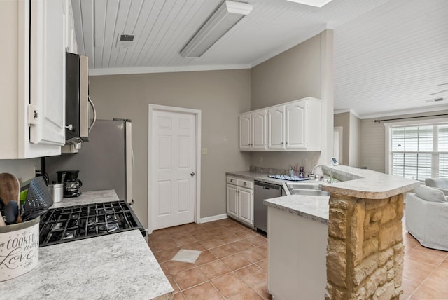 kitchen with appliances with stainless steel finishes, a sink, light tile patterned floors, a peninsula, and ornamental molding