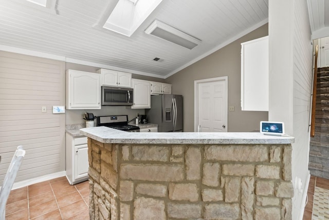 kitchen featuring white cabinets, crown molding, visible vents, stainless steel appliances, and vaulted ceiling