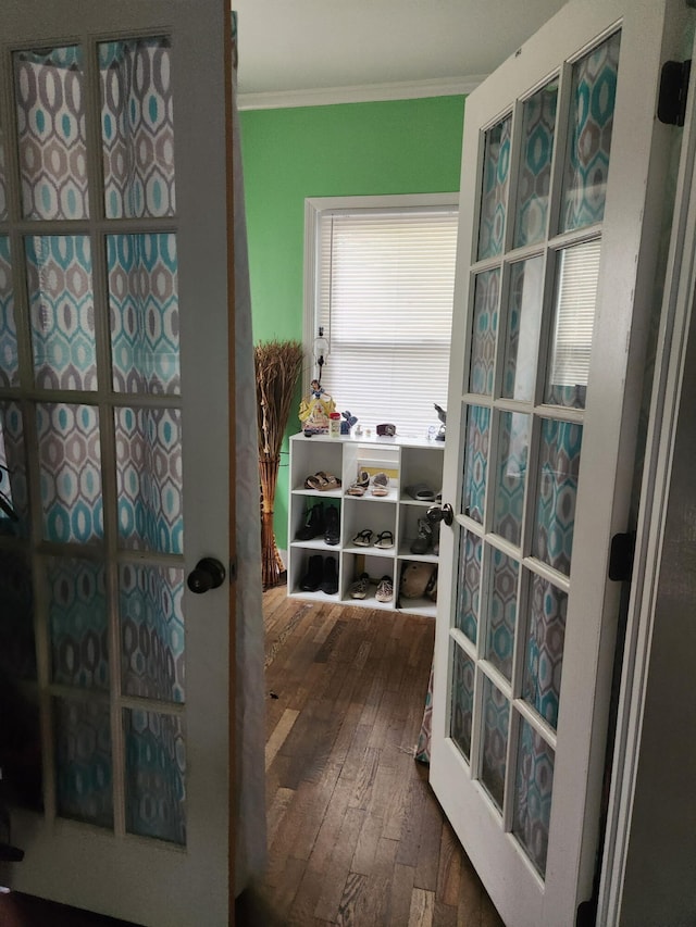 doorway to outside with wood-type flooring and crown molding