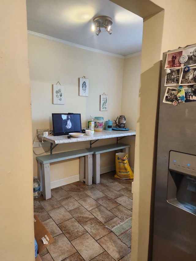 home office with crown molding and stone finish floor