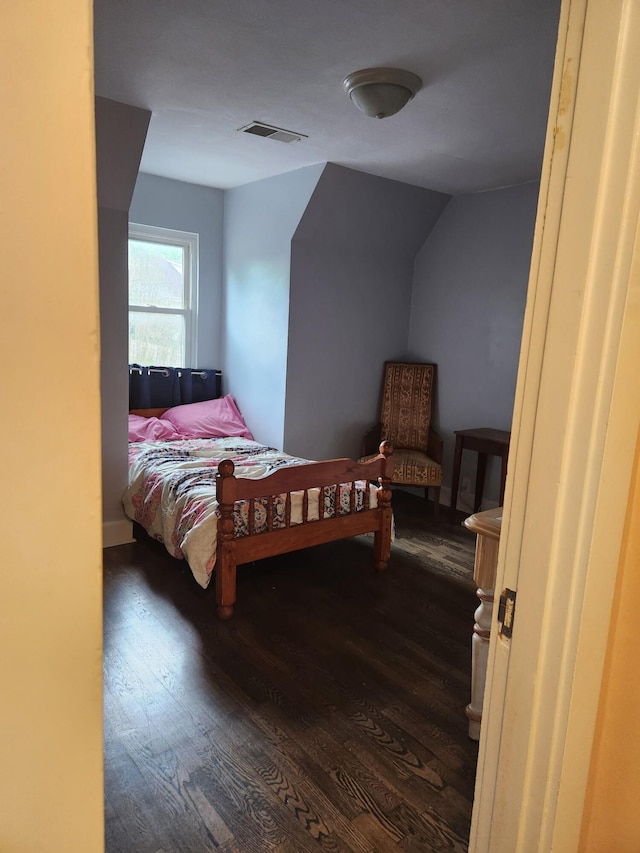 bedroom featuring dark wood finished floors and visible vents