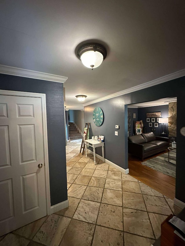 hallway with crown molding, baseboards, and stairs