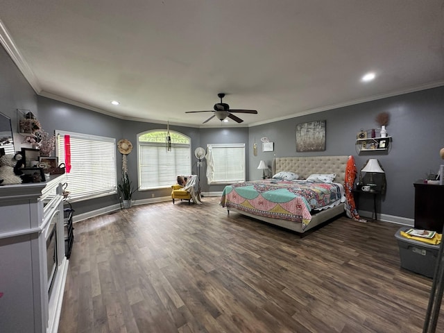 bedroom with crown molding, recessed lighting, baseboards, and wood finished floors
