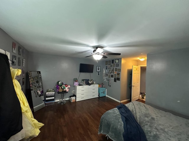 bedroom featuring a ceiling fan, baseboards, and wood finished floors