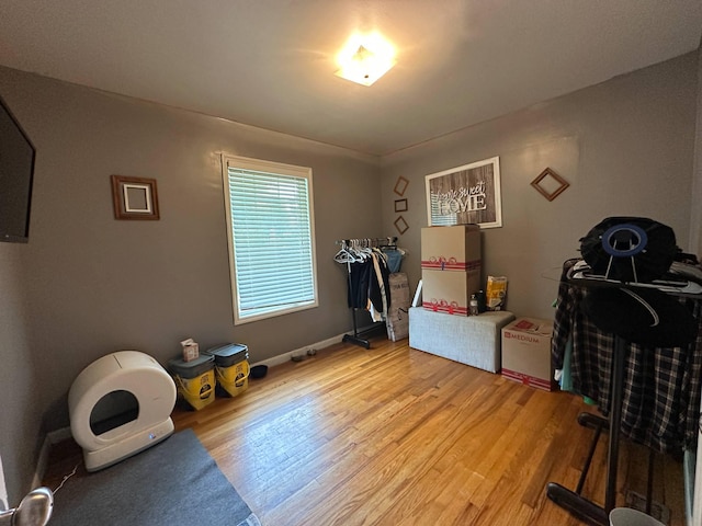 bedroom featuring light wood-type flooring and baseboards
