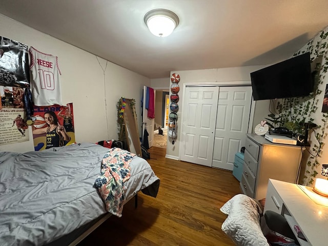 bedroom featuring a closet and dark wood finished floors