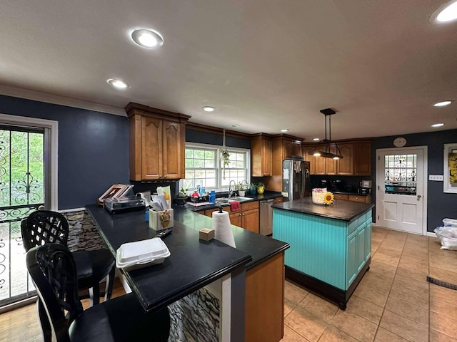kitchen featuring dark countertops, dishwasher, a sink, refrigerator with ice dispenser, and ornamental molding
