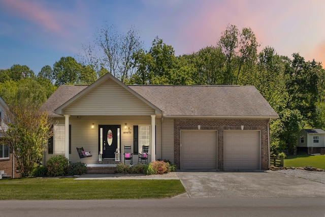 ranch-style home featuring an attached garage, covered porch, brick siding, and concrete driveway