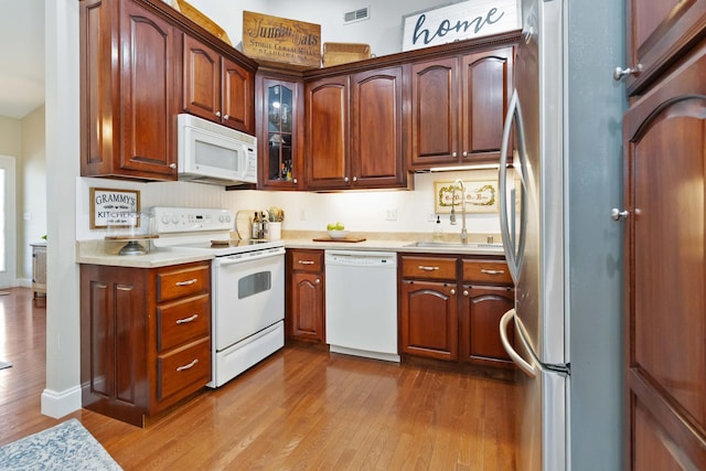 kitchen featuring white appliances, visible vents, dark wood finished floors, and light countertops