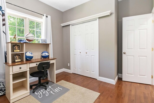 home office featuring baseboards and wood finished floors