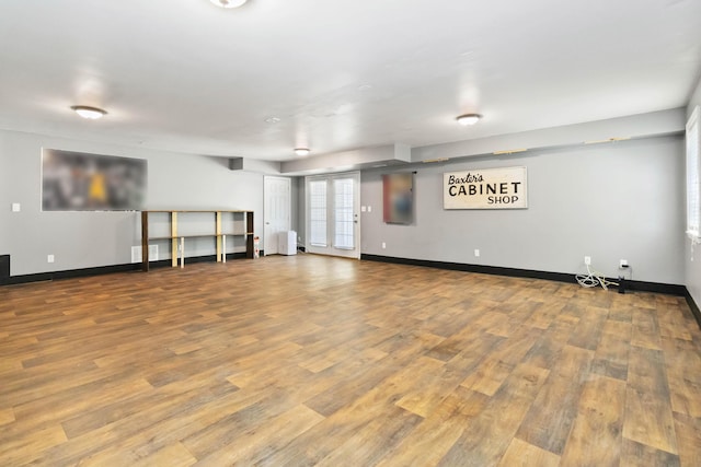 below grade area with baseboards and wood finished floors