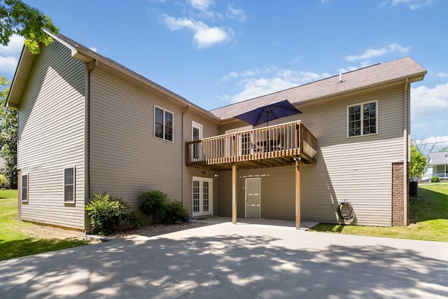 back of property with a patio area, a wooden deck, and french doors