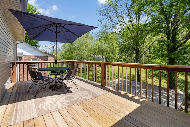 wooden terrace with outdoor dining area