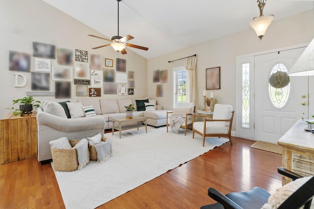living room featuring ceiling fan, wood finished floors, and high vaulted ceiling