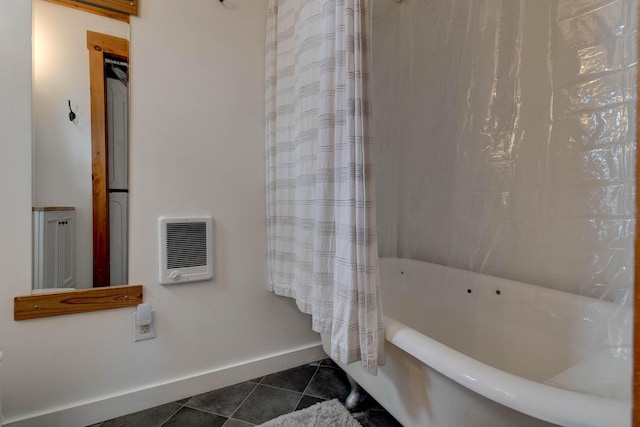 bathroom with heating unit, tile patterned floors, baseboards, and a washtub