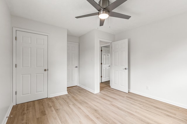 unfurnished bedroom featuring baseboards, a ceiling fan, and light wood finished floors