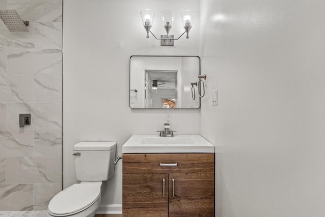 bathroom featuring vanity, ceiling fan, a tile shower, and toilet