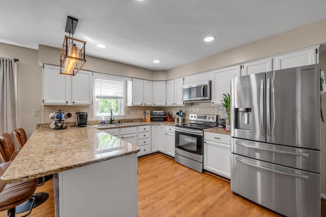 4805 Laurel Creek Cir, Lexington, KY 40515 - kitchen featuring appliances with stainless steel finishes, a peninsula, a sink, white cabinetry, and recessed lighting