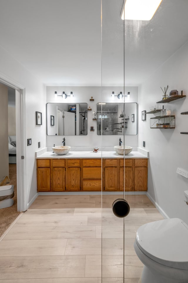 4805 Laurel Creek Cir, Lexington, KY 40515 - full bath with double vanity, wood finished floors, toilet, and baseboards