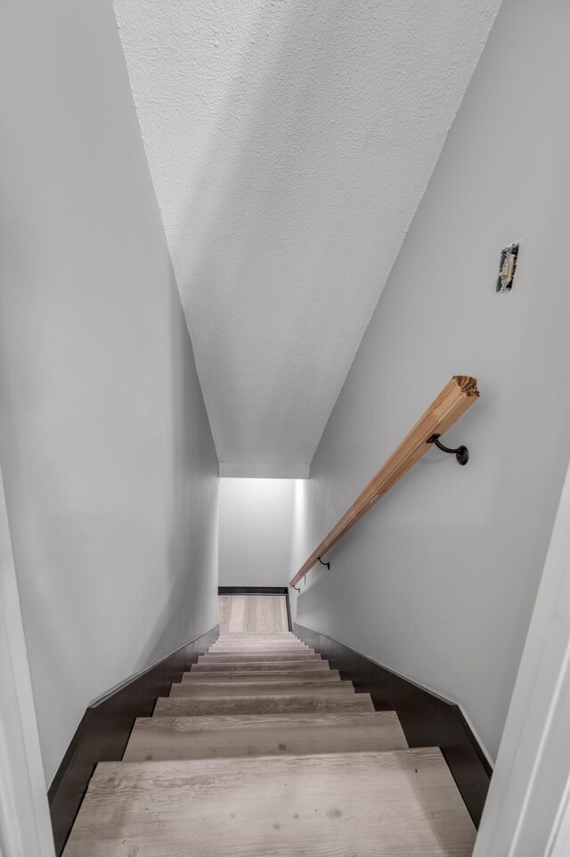 4805 Laurel Creek Cir, Lexington, KY 40515 - staircase featuring wood finished floors and a textured ceiling