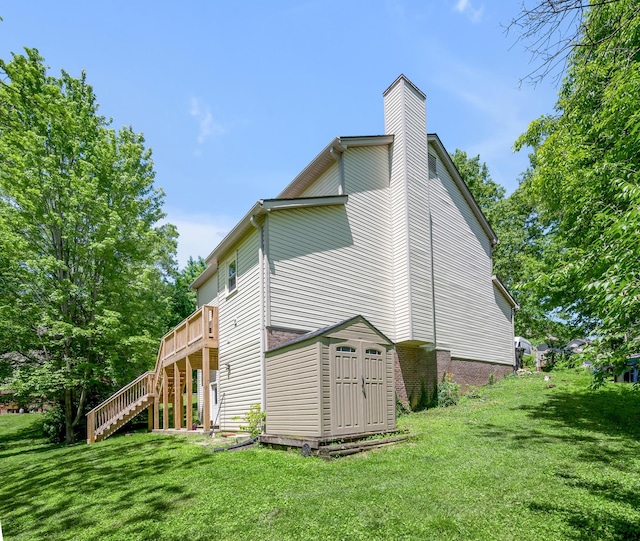 4805 Laurel Creek Cir, Lexington, KY 40515 - view of side of home featuring stairs, a yard, a deck, a chimney, and a storage unit