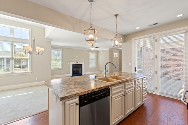 kitchen with dark wood-style flooring, a sink, a fireplace, ceiling fan with notable chandelier, and stainless steel dishwasher
