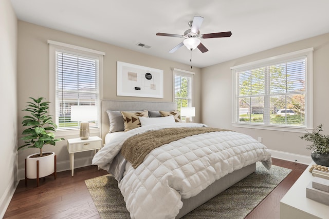 bedroom featuring visible vents, baseboards, and dark wood-type flooring