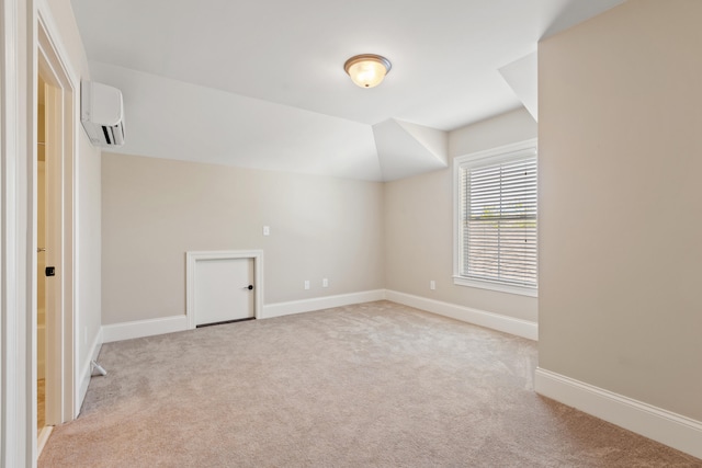 interior space with baseboards, an AC wall unit, and carpet flooring