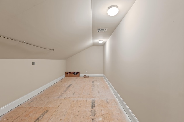 bonus room with visible vents, baseboards, and lofted ceiling