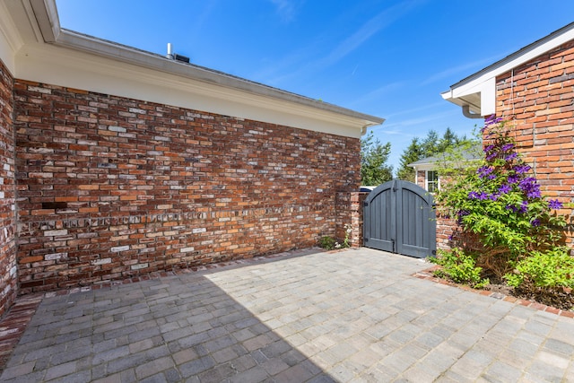 view of patio with a gate