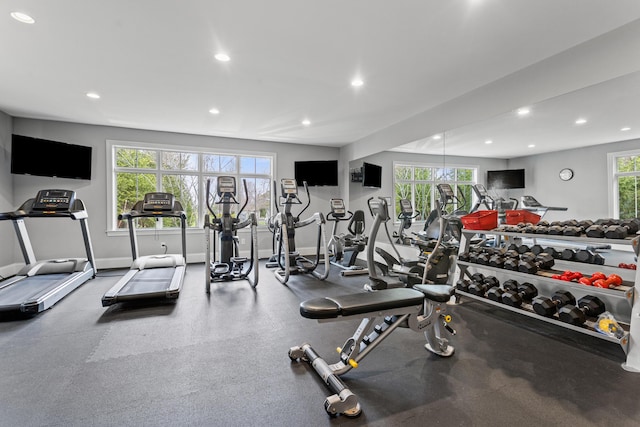 exercise room with recessed lighting and baseboards
