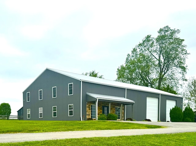 exterior space featuring a front yard and metal roof