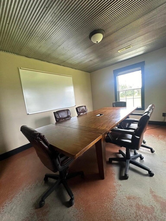 home office with carpet flooring, baseboards, and visible vents