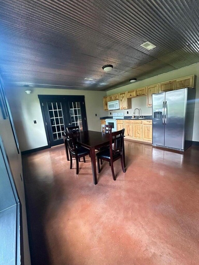 dining room with french doors, finished concrete floors, and visible vents