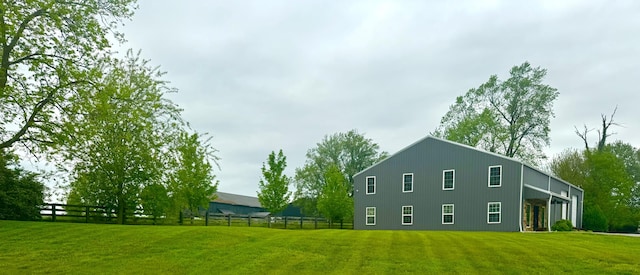 view of home's exterior with a yard and fence
