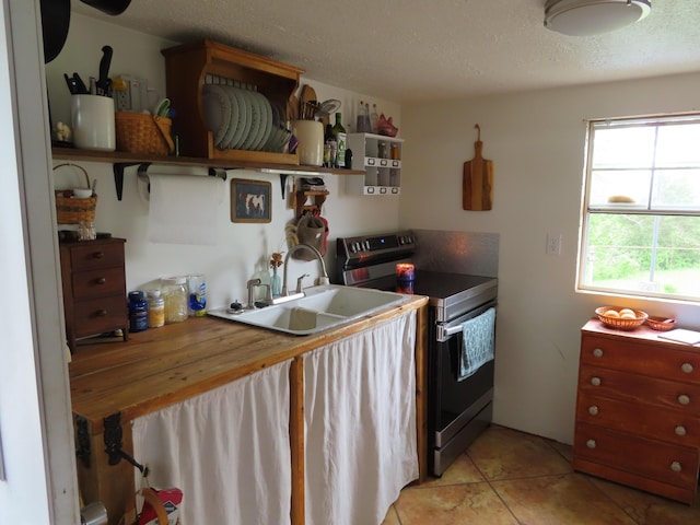4362 Poor Ridge Pike, Lancaster, KY 40444 - kitchen with a textured ceiling, open shelves, stainless steel range with electric stovetop, a sink, and light tile patterned floors