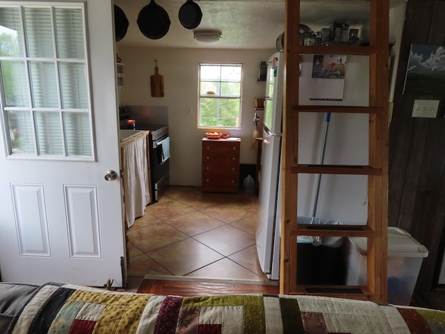 4362 Poor Ridge Pike, Lancaster, KY 40444 - interior space featuring light tile patterned floors, freestanding refrigerator, and stainless steel range with electric cooktop
